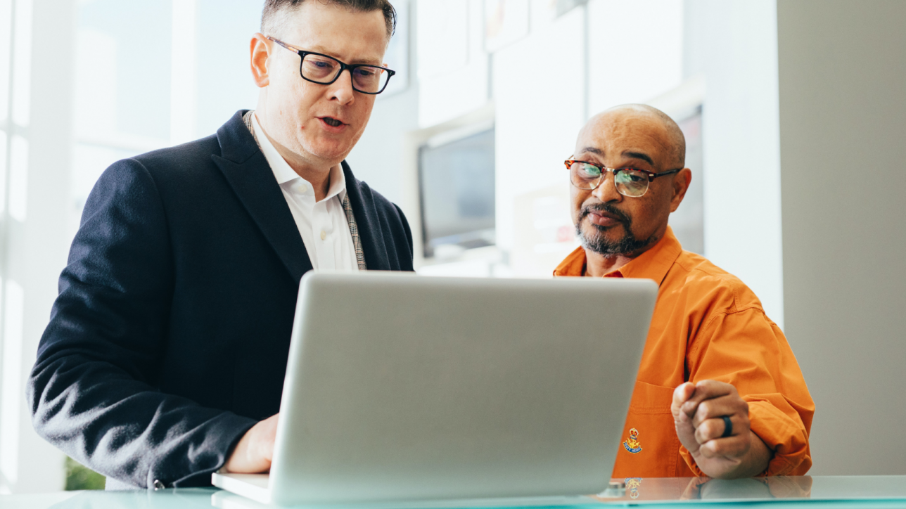 Two men looking at laptop