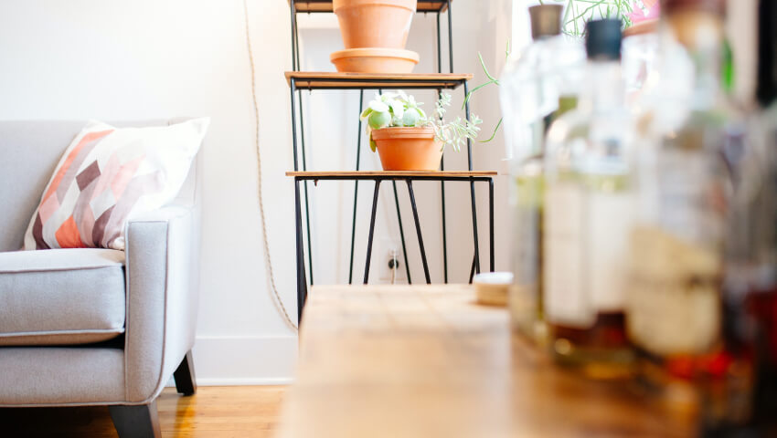 clay pots on metal shelves in condo with wood floors
