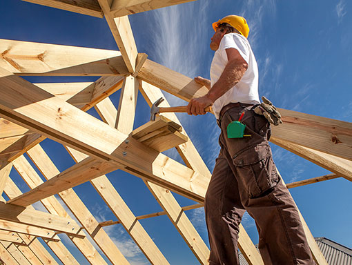 roofer worker builder working on roof structure at construction site Construction worker building a frame