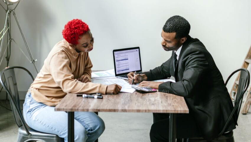 do-consultants-need-general-liability-insurance Consultant helping client looking over papers