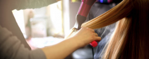 Hairdresser blowing a woman's hair