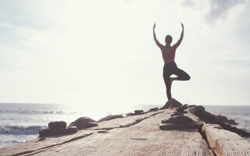 healthy-mindset-top woman doing yoga pose on top of mountain