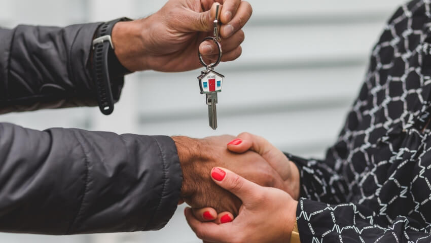 Man handing keys over to a woman