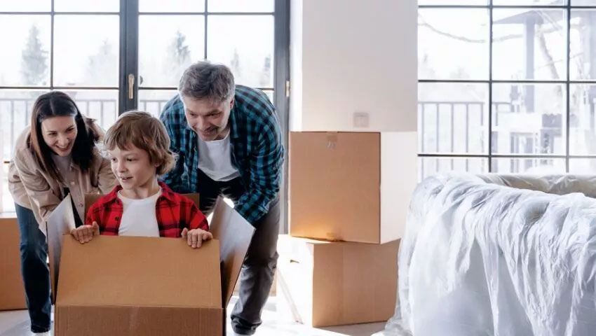 mom and dad unpacking box with child