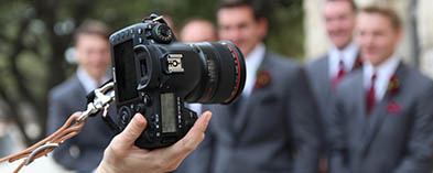 photographer taking a photo of wedding party