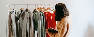 woman viewing clothes on retail rack