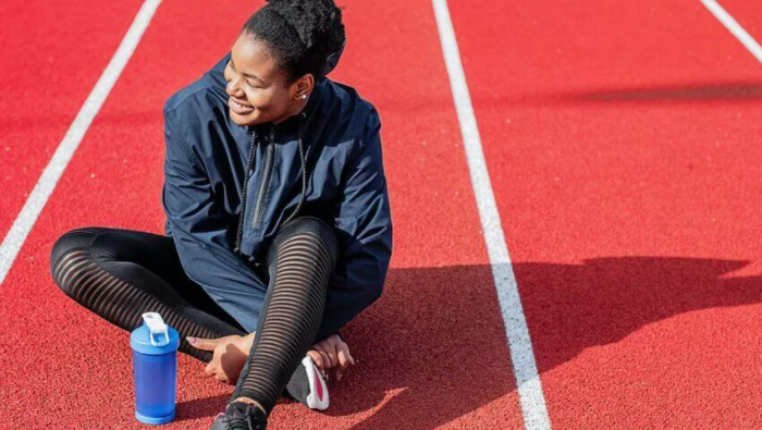 what-kind-of-insurance-do-i-need-as-a-personal-trainer woman runner sitting on running track