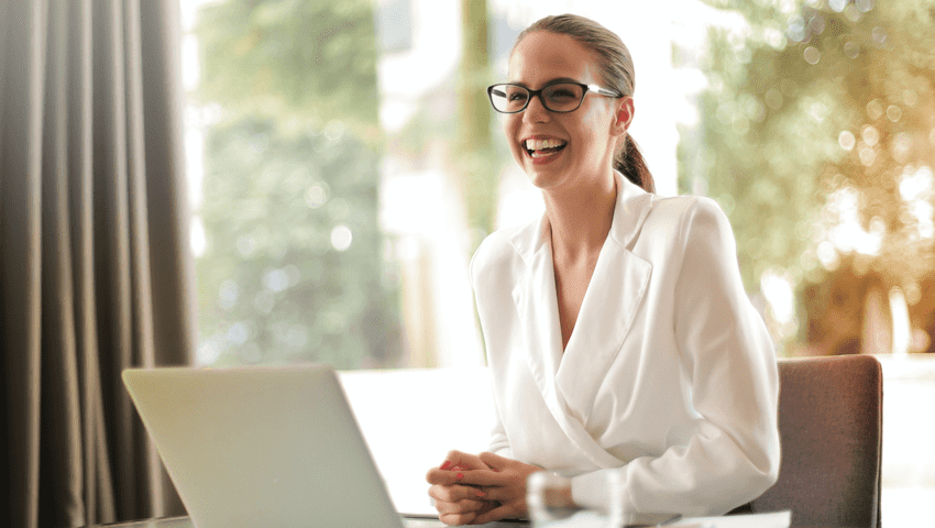 woman sitting at desk smiling