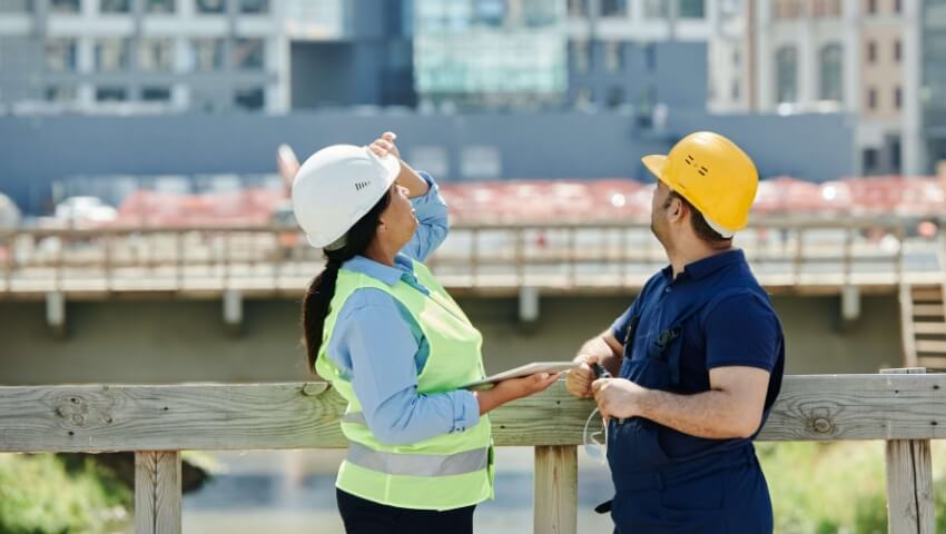 Two construction workers looking up